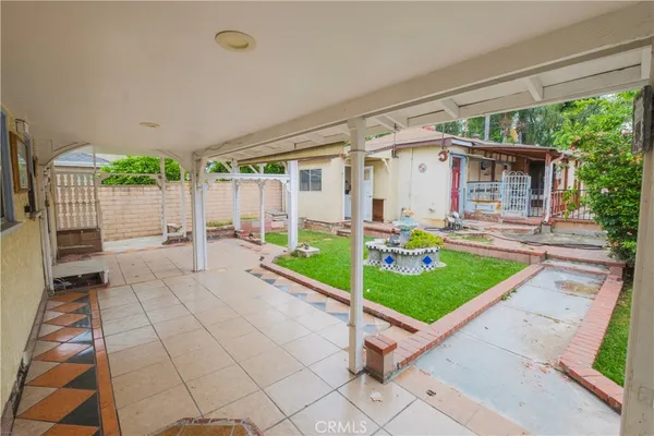 a view of a porch with furniture and garden