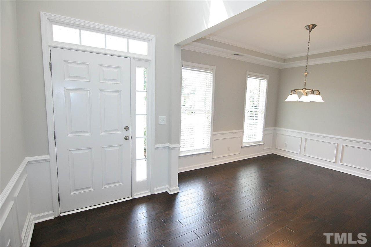 3401 Parlor Street Raleigh, NC 27614 - Photo 3 of 25 a view of an empty room with wooden floor and a window