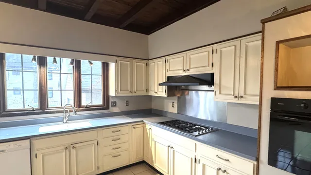 a kitchen with a sink and large window