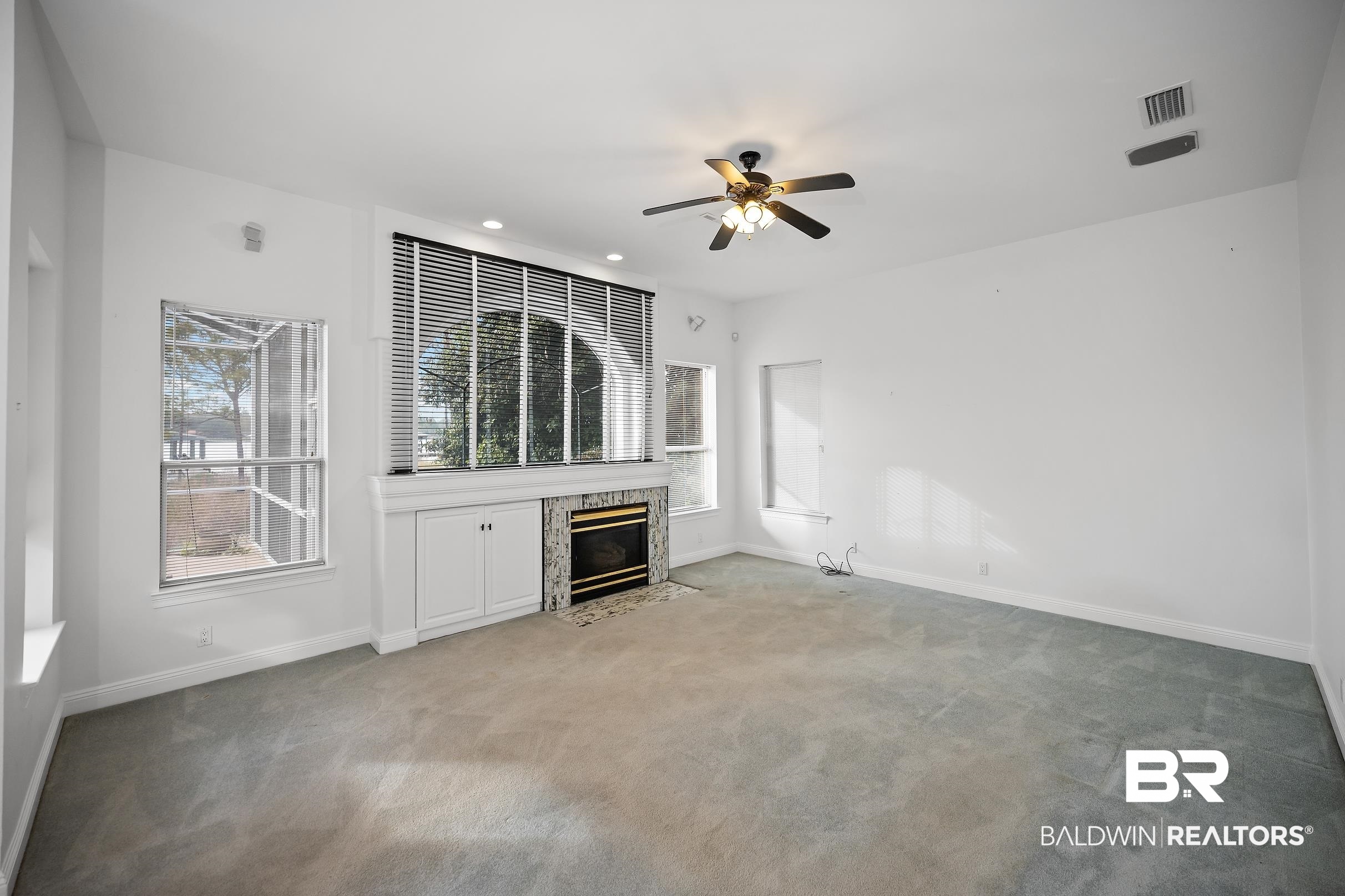 8591 Bay Harbor Road Elberta, AL 36530 - Photo 17 of 56 Unfurnished living room featuring a fireplace, carpet flooring, recessed lighting, and a ceiling fan