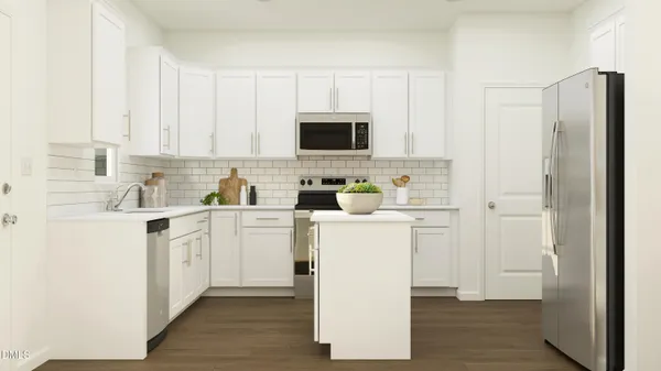 a kitchen with a refrigerator sink and cabinets