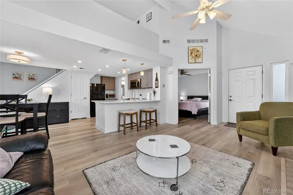 a living room with furniture and a wooden floor