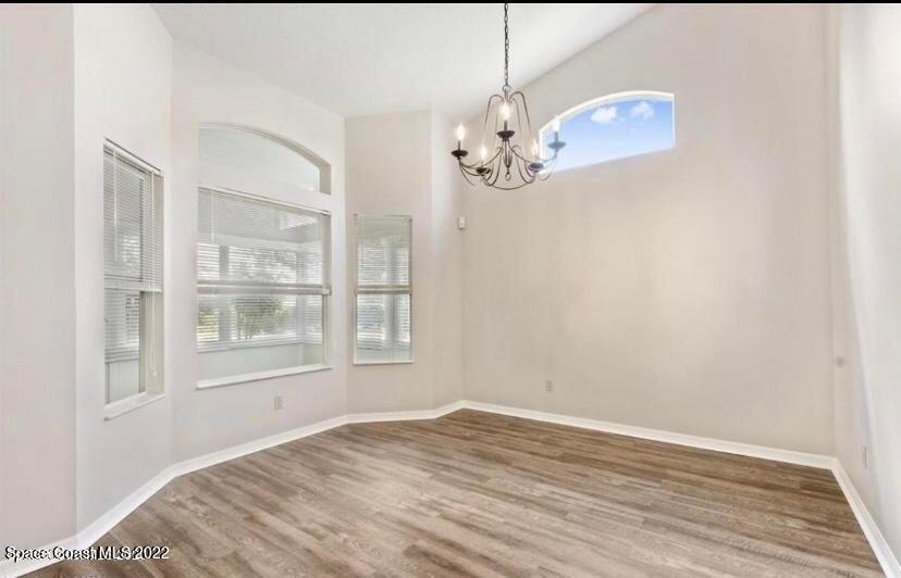 468 Prestwick Court Melbourne, FL 32940 - Photo 11 of 13 a view of empty room with wooden floor and window