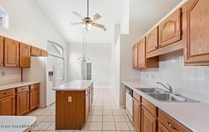 468 Prestwick Court Melbourne, FL 32940 - Photo 12 of 13 a kitchen with stainless steel appliances granite countertop a sink a stove and a refrigerator