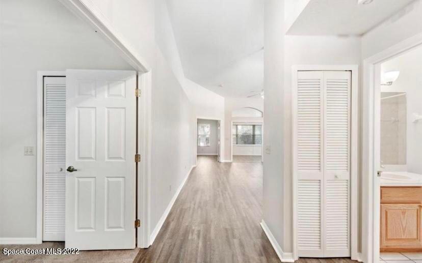 468 Prestwick Court Melbourne, FL 32940 - Photo 3 of 13 a view of a hallway with wooden floor and closet area