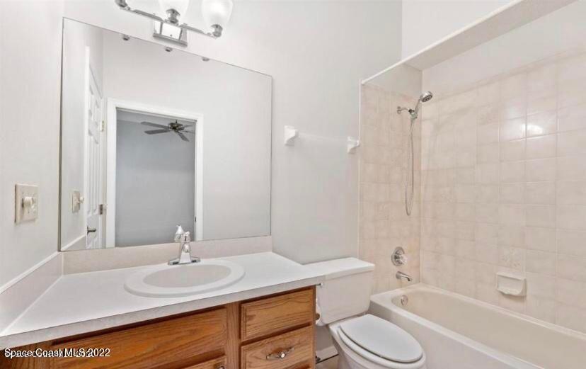 468 Prestwick Court Melbourne, FL 32940 - Photo 5 of 13 a bathroom with a granite countertop sink toilet a mirror and shower