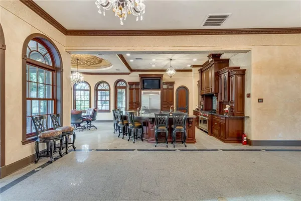 a kitchen with stainless steel appliances granite countertop a refrigerator and a stove top oven