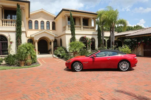 a living room with patio furniture and a chandelier