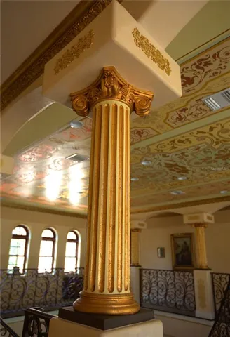 a living room with furniture a chandelier and a rug