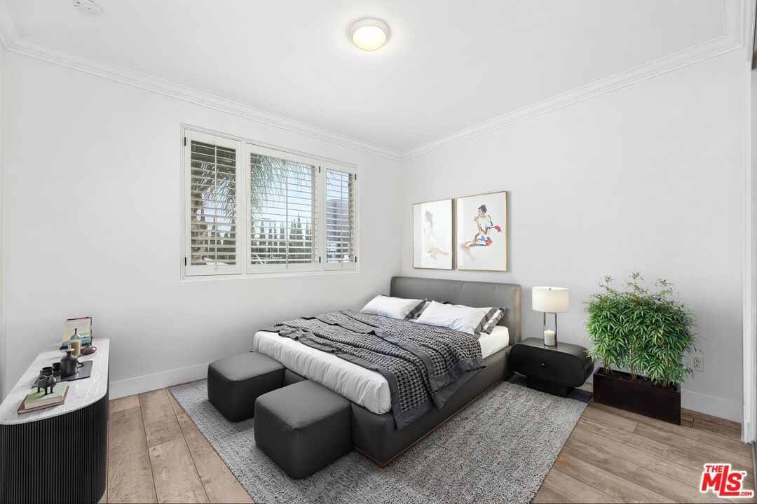 11974 Mayfield Avenue, Unit 2 Los Angeles, CA 90049 - Photo 11 of 26 a bedroom with a bed and a couch