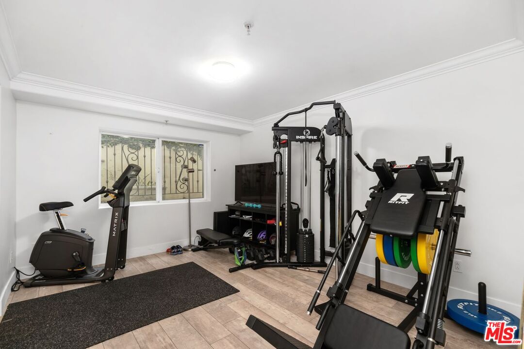 11974 Mayfield Avenue, Unit 2 Los Angeles, CA 90049 - Photo 13 of 26 a living room with furniture and a flat screen tv