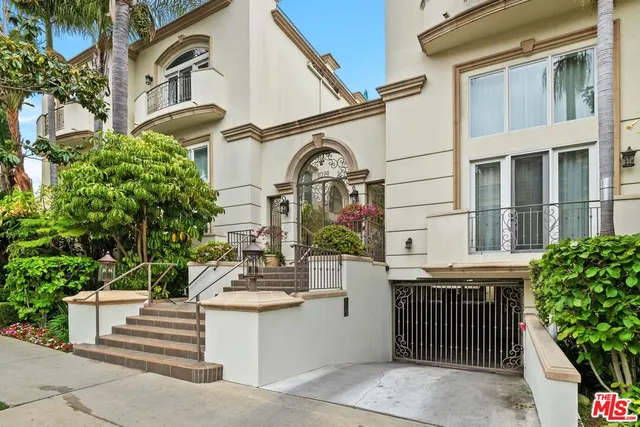a view of a tall building with a tree in front of it