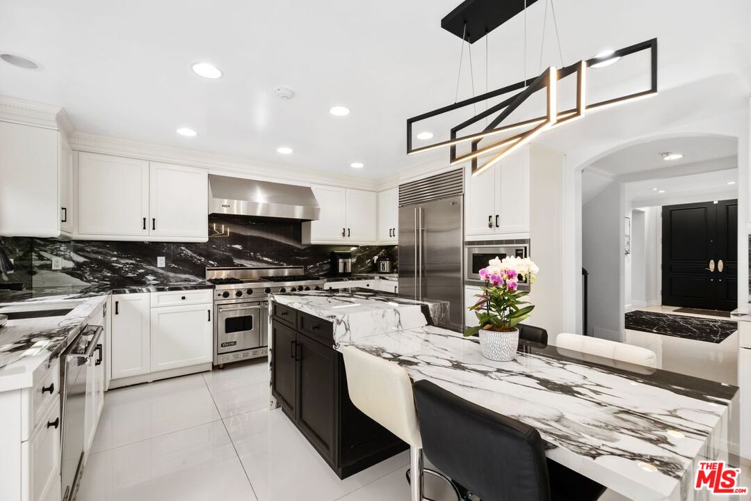 11974 Mayfield Avenue, Unit 2 Los Angeles, CA 90049 - Photo 19 of 26 a kitchen with a sink stove and cabinets