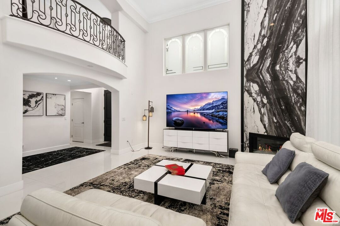11974 Mayfield Avenue, Unit 2 Los Angeles, CA 90049 - Photo 22 of 26 a living room with furniture and a flat screen tv