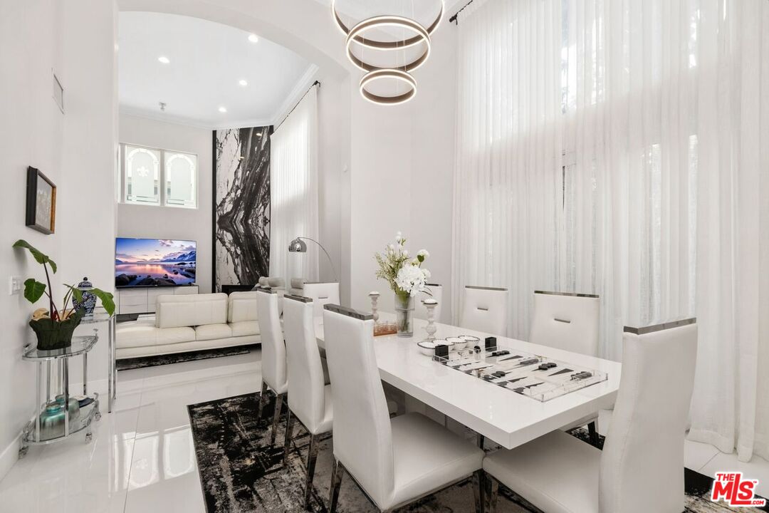 11974 Mayfield Avenue, Unit 2 Los Angeles, CA 90049 - Photo 23 of 26 a view of a dining room with furniture window and wooden floor