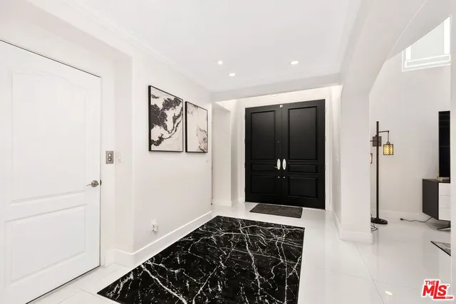 a view of a white house with a yard and plants