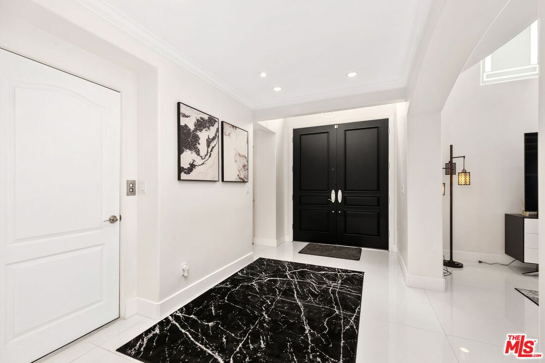 11974 Mayfield Avenue, Unit 2 Los Angeles, CA 90049 - Photo 25 of 26 a view of a hallway with wooden floor and a bathroom