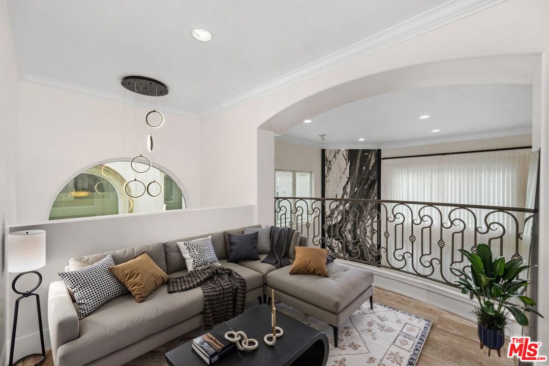 11974 Mayfield Avenue, Unit 2 Los Angeles, CA 90049 - Photo 7 of 26 a living room with furniture and wooden floor