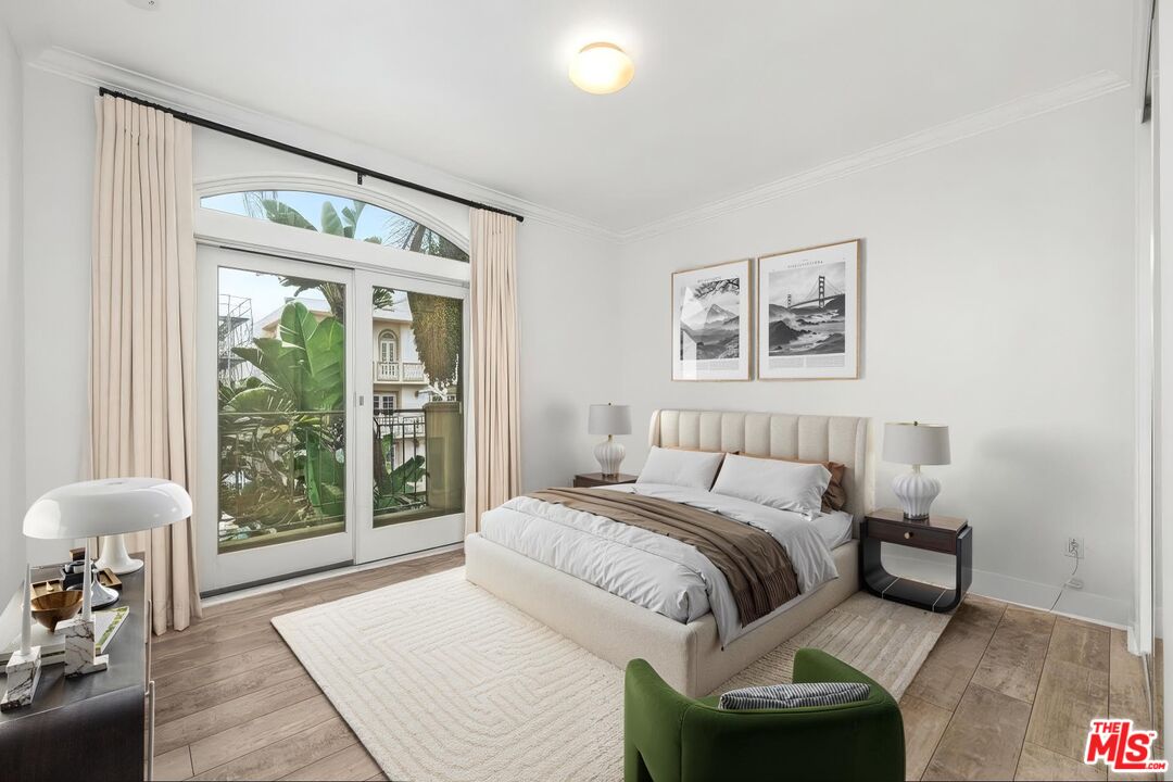 11974 Mayfield Avenue, Unit 2 Los Angeles, CA 90049 - Photo 10 of 26 a bedroom with a large bed and a large window