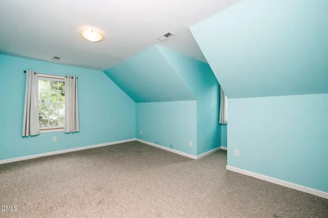 a view of an empty room with windows