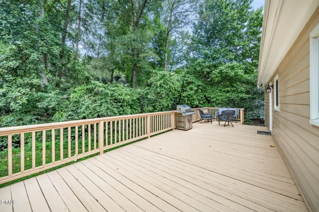a balcony with wooden floor and fence