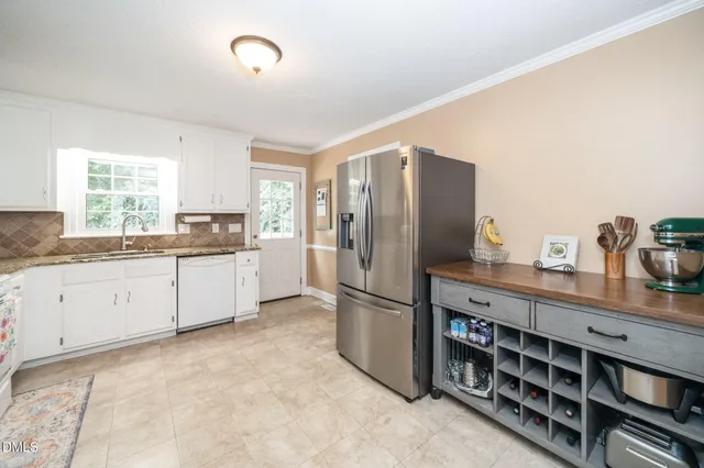 a kitchen with stainless steel appliances granite countertop a stove a refrigerator and a cabinets
