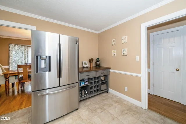 a kitchen with stainless steel appliances a refrigerator sink and cabinets