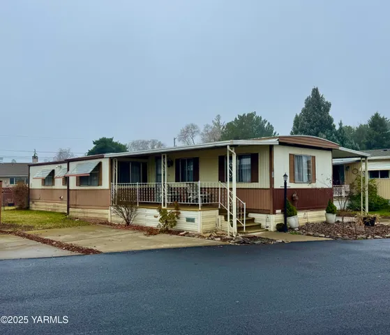 a house that has a big yard in front of it