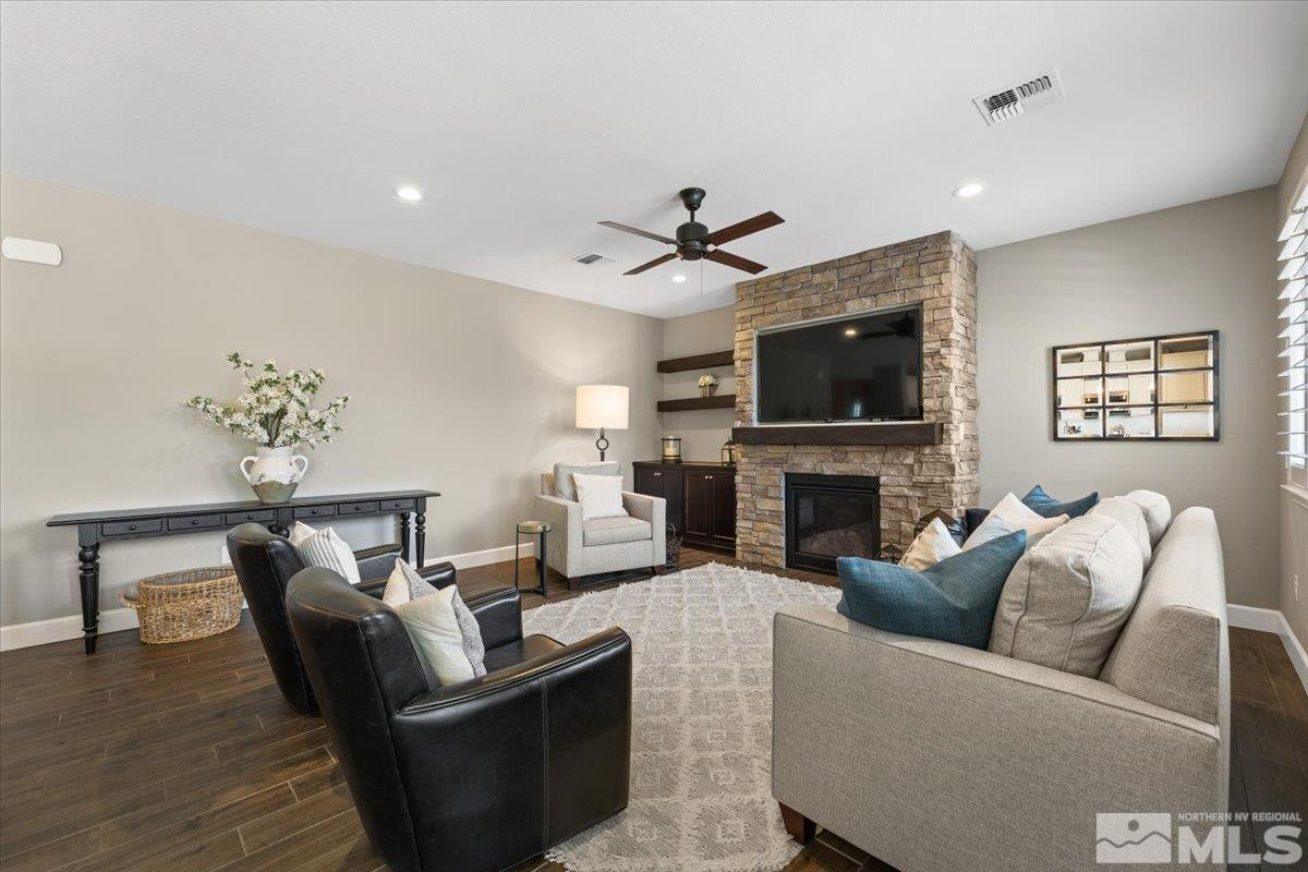 9543 Tencendur Lane Reno, NV 89521 - Photo 13 of 40 a living room with furniture a fireplace and a flat screen tv