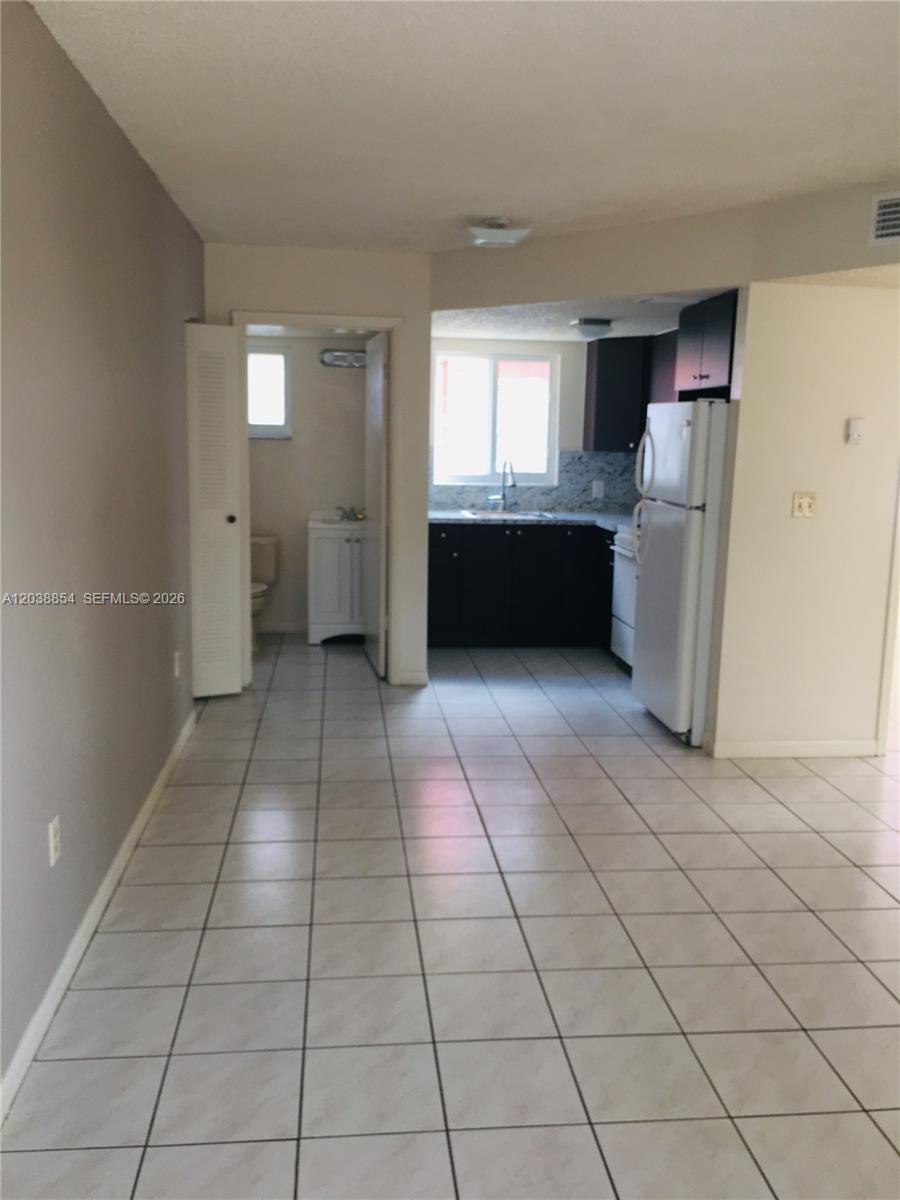 1419 Southwest 22nd Avenue Miami, FL 33145 - Photo 16 of 20 a view of kitchen with windows and refrigerator