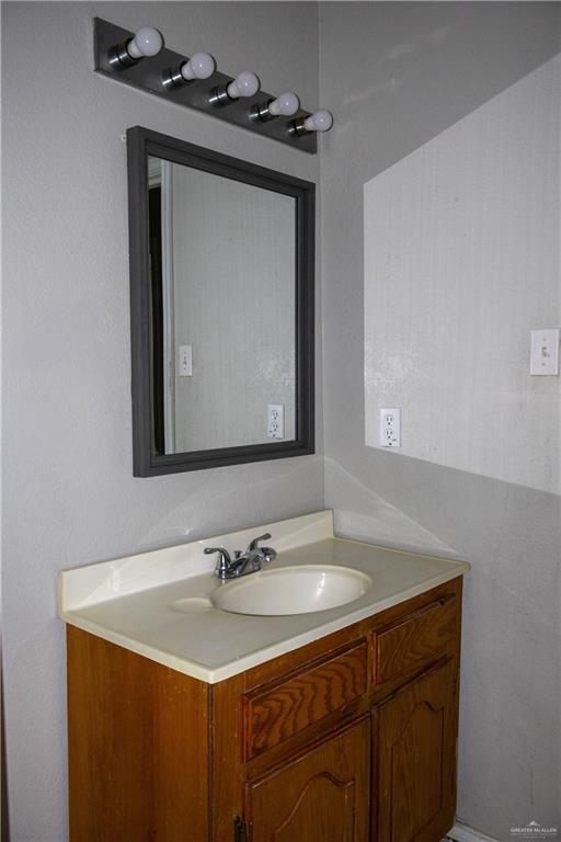 3301 South McColl Road McAllen, TX 78503 - Photo 17 of 28 a bathroom with a sink vanity and a mirror