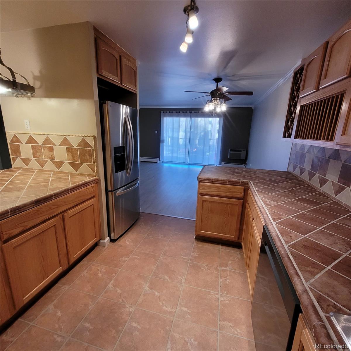 755 South Clinton Street, Unit 6B Denver, CO 80247 - Photo 18 of 48 a kitchen with stainless steel appliances granite countertop a stove a sink and a refrigerator