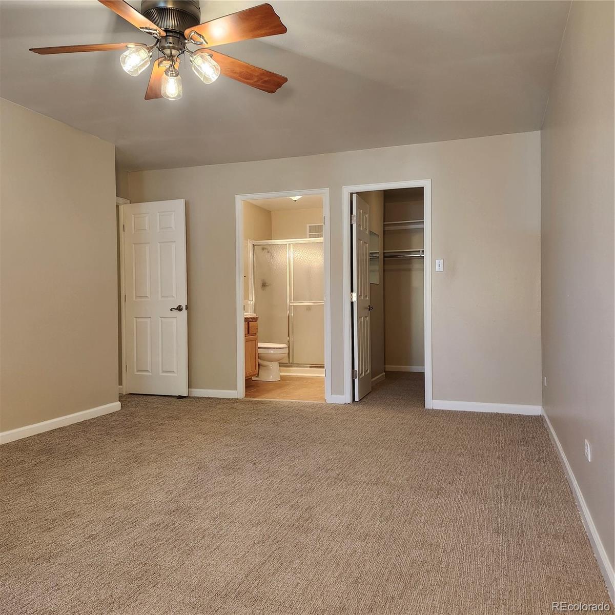 755 South Clinton Street, Unit 6B Denver, CO 80247 - Photo 25 of 48 an empty room with closet and a chandelier fan