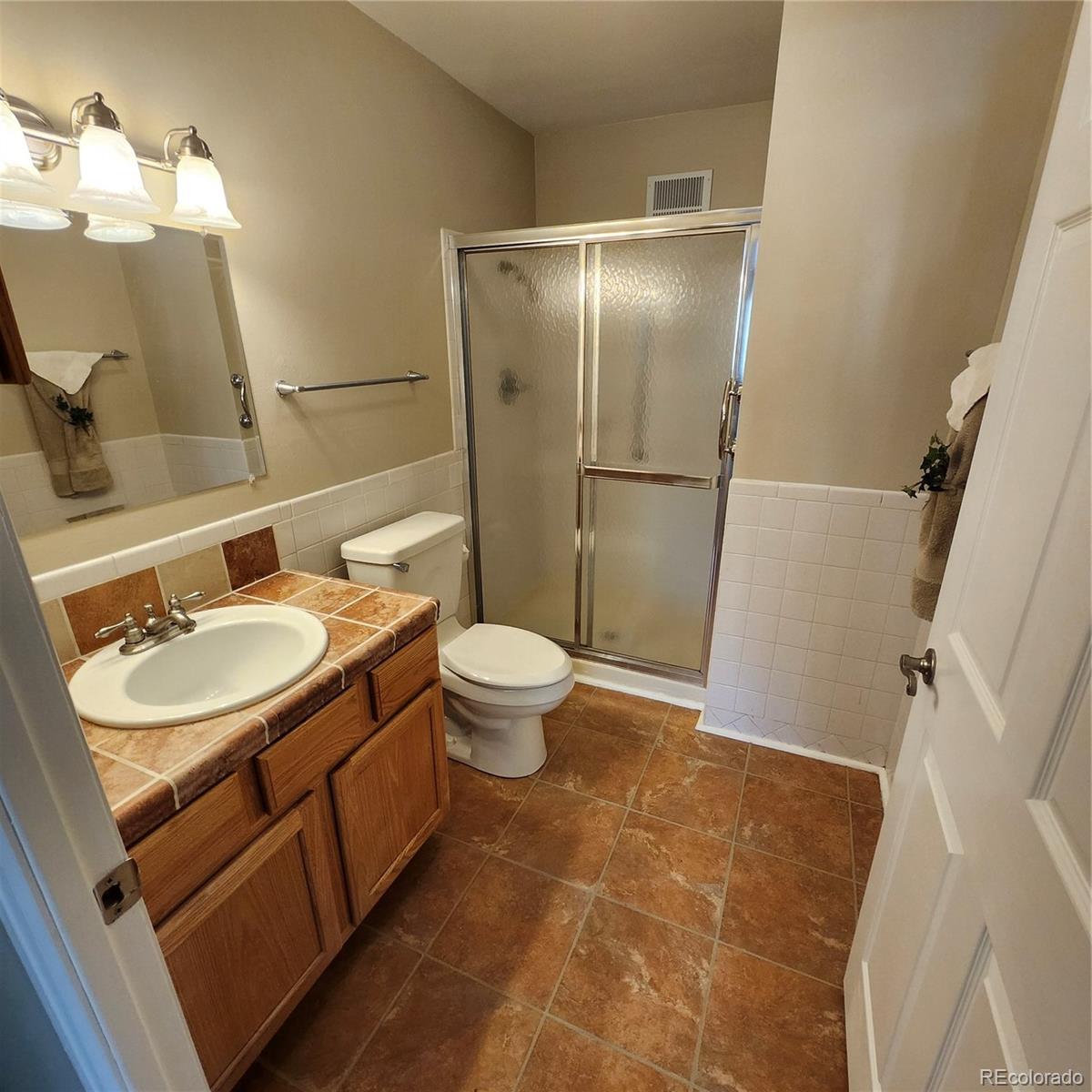 755 South Clinton Street, Unit 6B Denver, CO 80247 - Photo 27 of 48 a bathroom with a sink toilet and shower