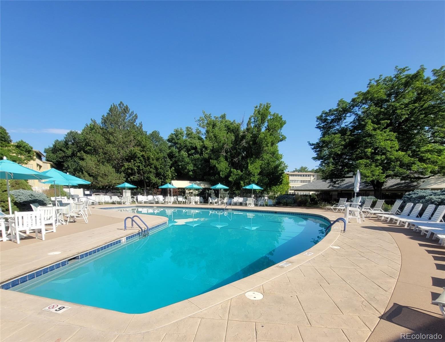 755 South Clinton Street, Unit 6B Denver, CO 80247 - Photo 32 of 48 a view of a swimming pool with lounge chairs