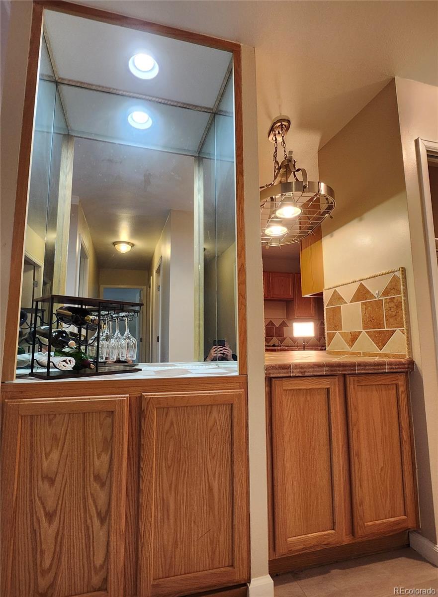 755 South Clinton Street, Unit 6B Denver, CO 80247 - Photo 4 of 48 a bathroom with a mirror and a sink
