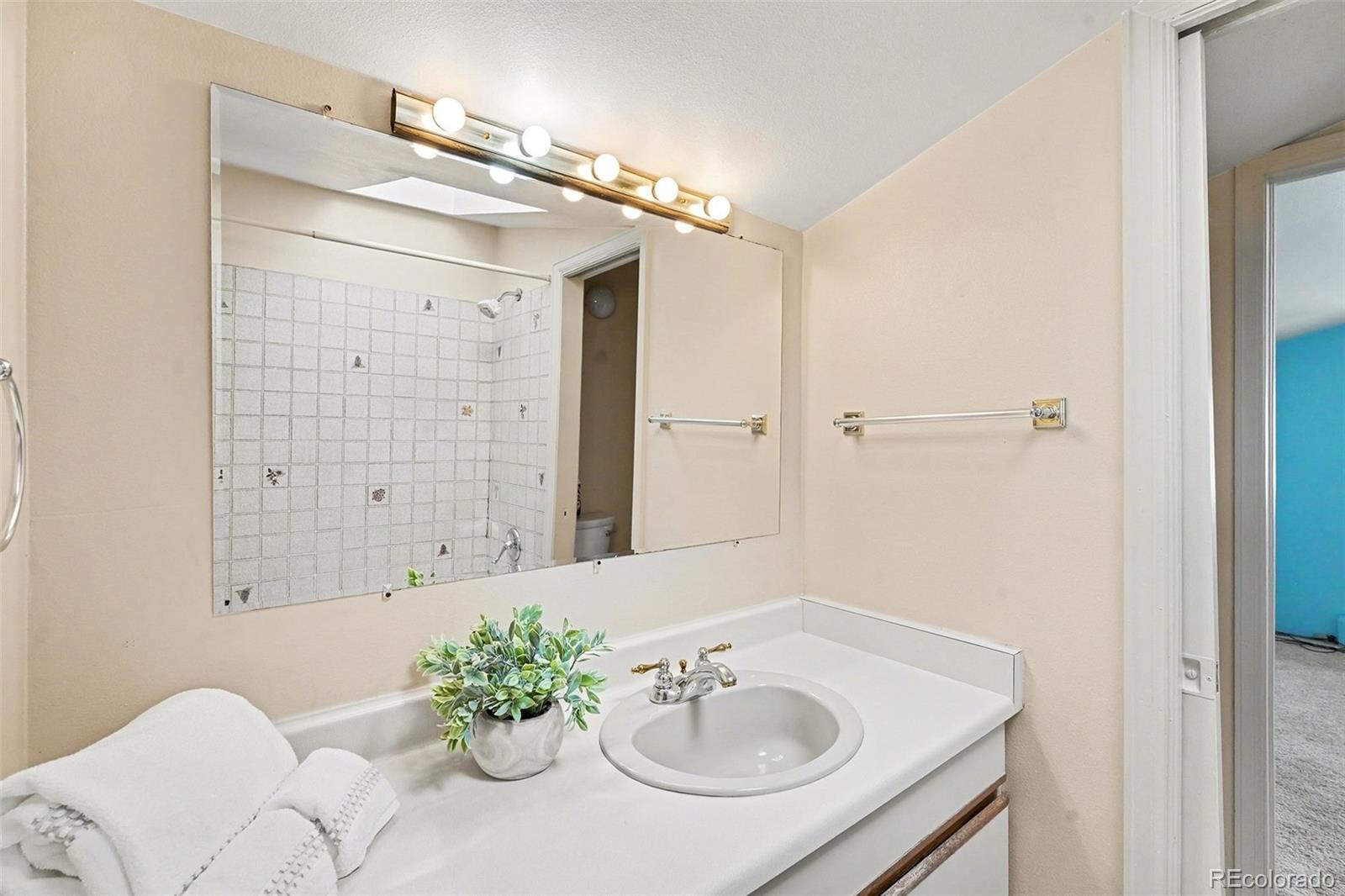 2222 Meade Street Denver, CO 80211 - Photo 13 of 19 a bathroom with a sink shower and a mirror