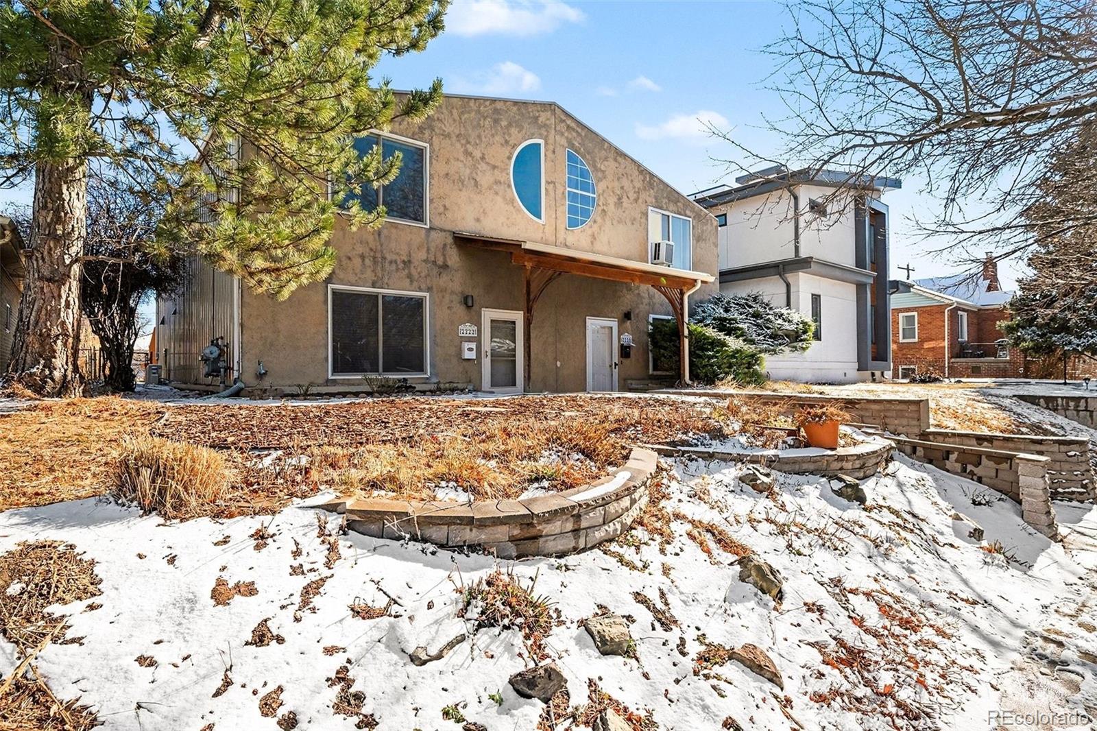 2222 Meade Street Denver, CO 80211 - Photo 18 of 19 a view of a white house with a yard covered in snow