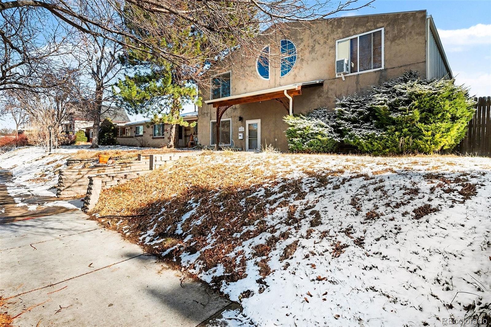 2222 Meade Street Denver, CO 80211 - Photo 3 of 19 a front view of a house with a yard covered with snow