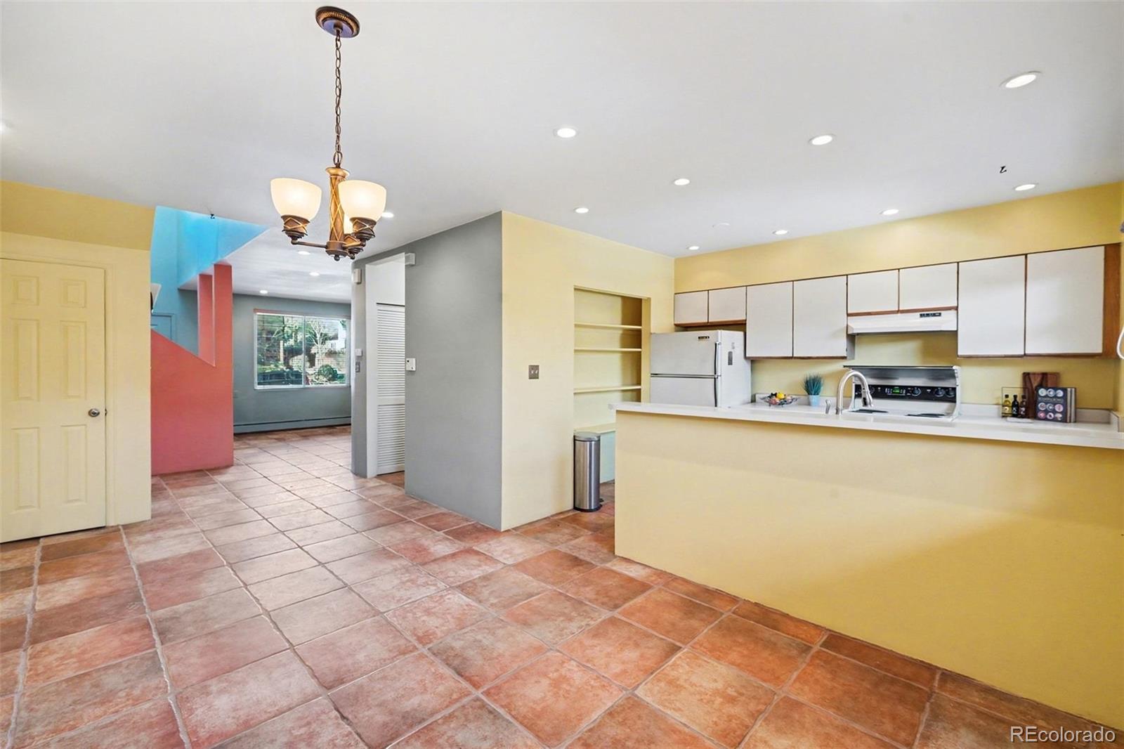 2222 Meade Street Denver, CO 80211 - Photo 6 of 19 a view of a kitchen with stainless steel appliances granite countertop a refrigerator and a stove top oven