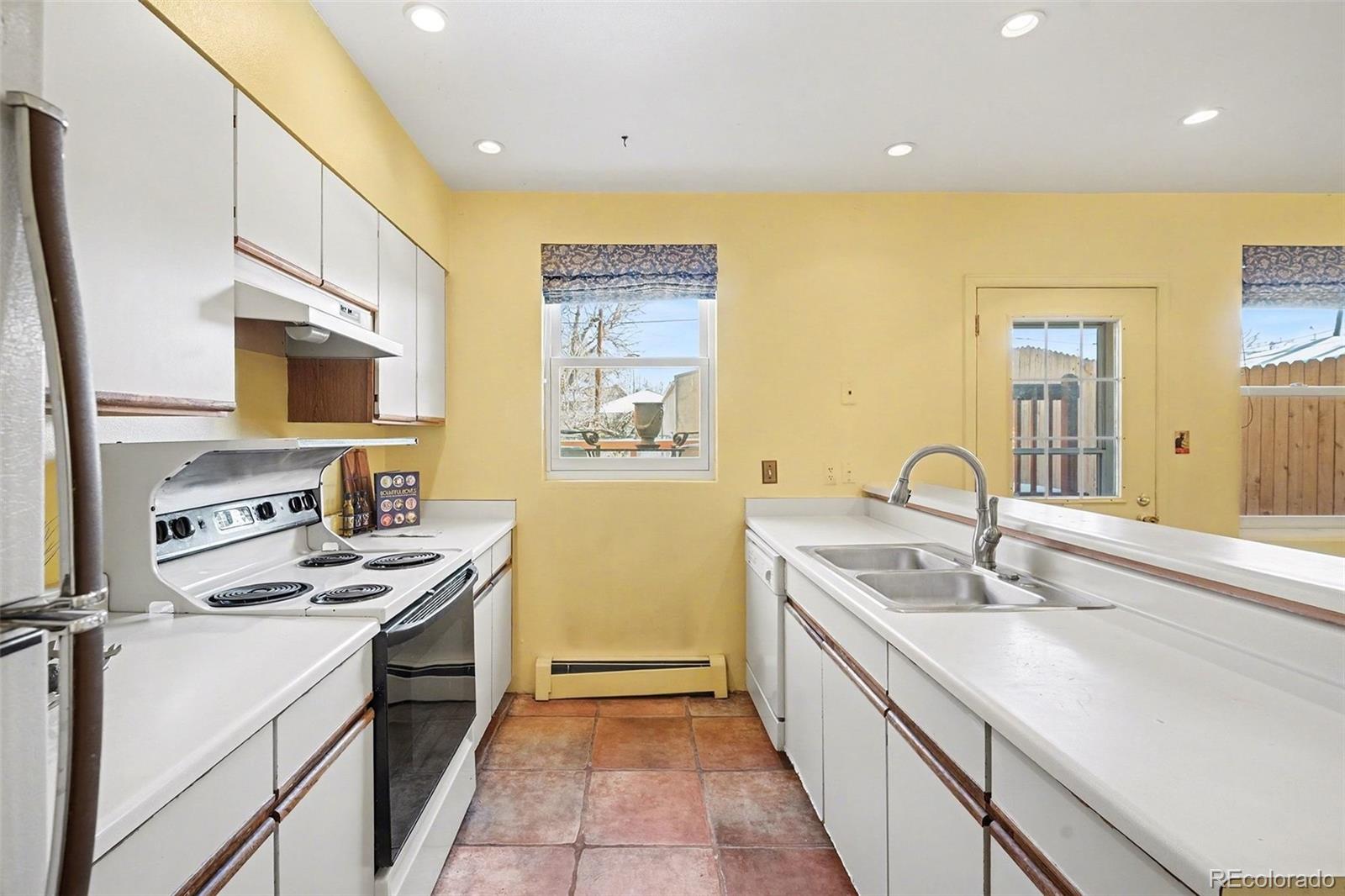 2222 Meade Street Denver, CO 80211 - Photo 8 of 19 a kitchen with a sink stove top oven and refrigerator
