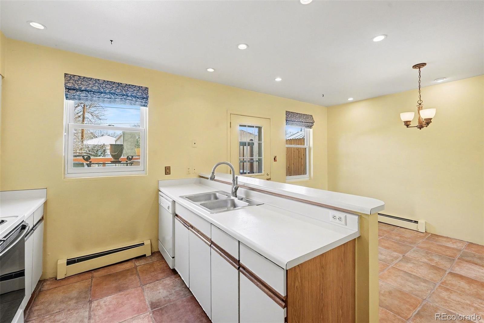 2222 Meade Street Denver, CO 80211 - Photo 9 of 19 a bathroom with a sink a mirror and vanity