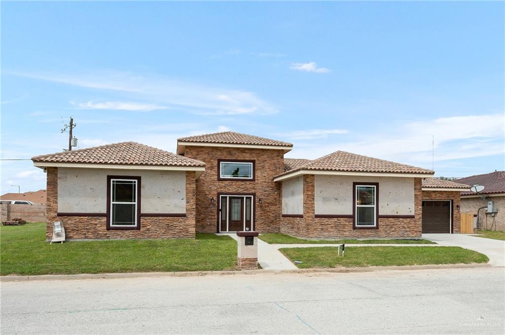 1127 Fairway Lane Harlingen, TX 78552 - Photo 1 of 23 a front view of a house with a yard