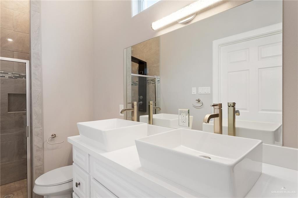 1127 Fairway Lane Harlingen, TX 78552 - Photo 12 of 23 a bathroom with a sink a toilet and shower