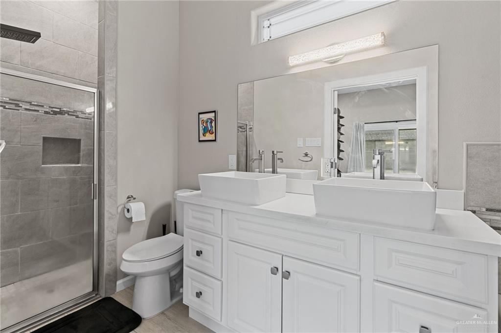 1127 Fairway Lane Harlingen, TX 78552 - Photo 13 of 23 a bathroom with a toilet sink and shower