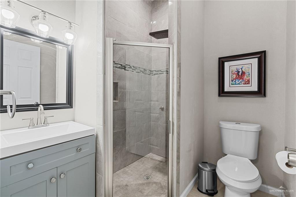 1127 Fairway Lane Harlingen, TX 78552 - Photo 16 of 23 a bathroom with a toilet sink and shower