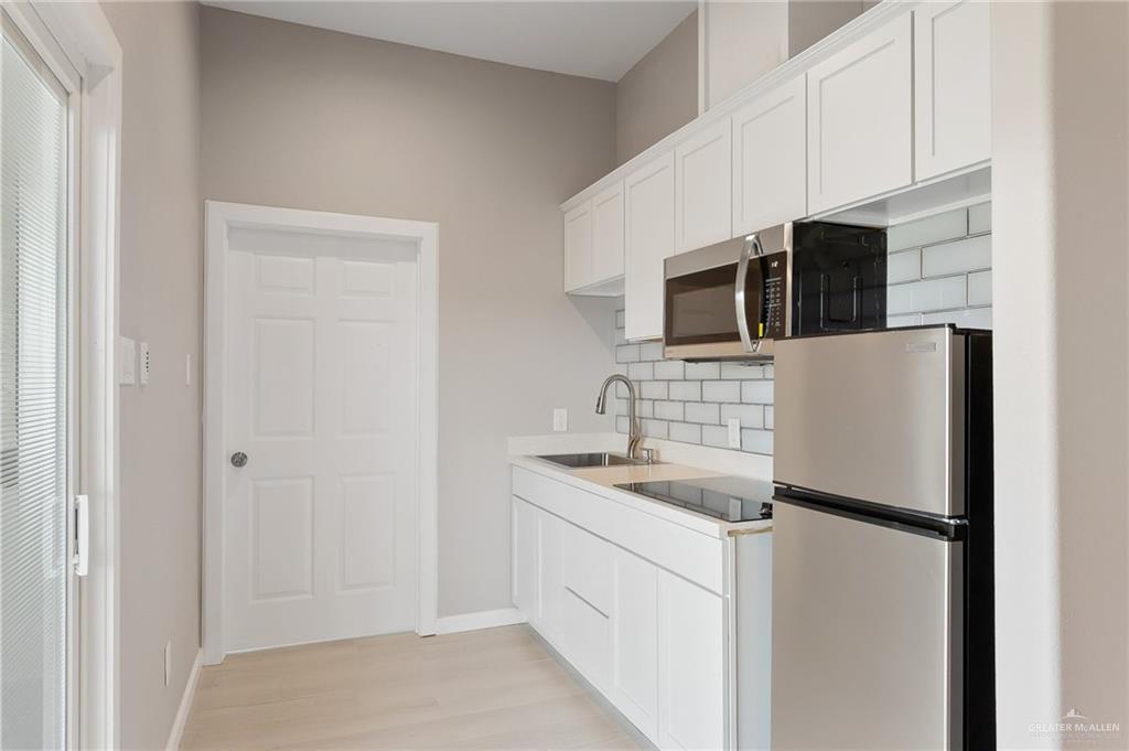 1127 Fairway Lane Harlingen, TX 78552 - Photo 18 of 23 a kitchen with stainless steel appliances a refrigerator sink and microwave