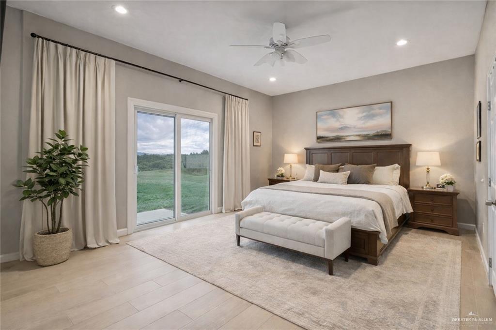1127 Fairway Lane Harlingen, TX 78552 - Photo 8 of 23 a spacious bedroom with a large bed and a chandelier