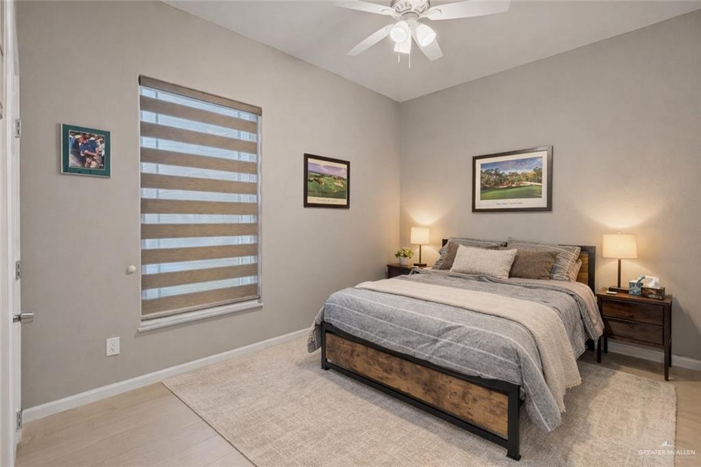 1127 Fairway Lane Harlingen, TX 78552 - Photo 10 of 23 a bedroom with a bed and a painting on the wall