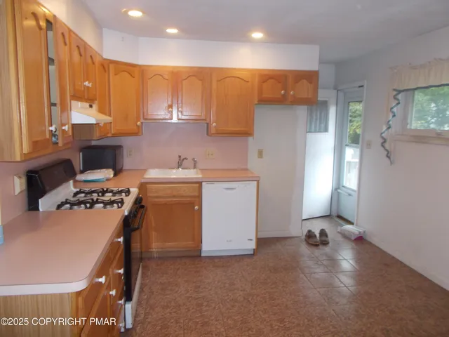 a kitchen that has a sink and a stove